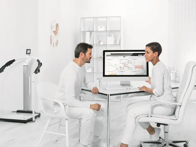 Adult and clinician reviewing body-composition information