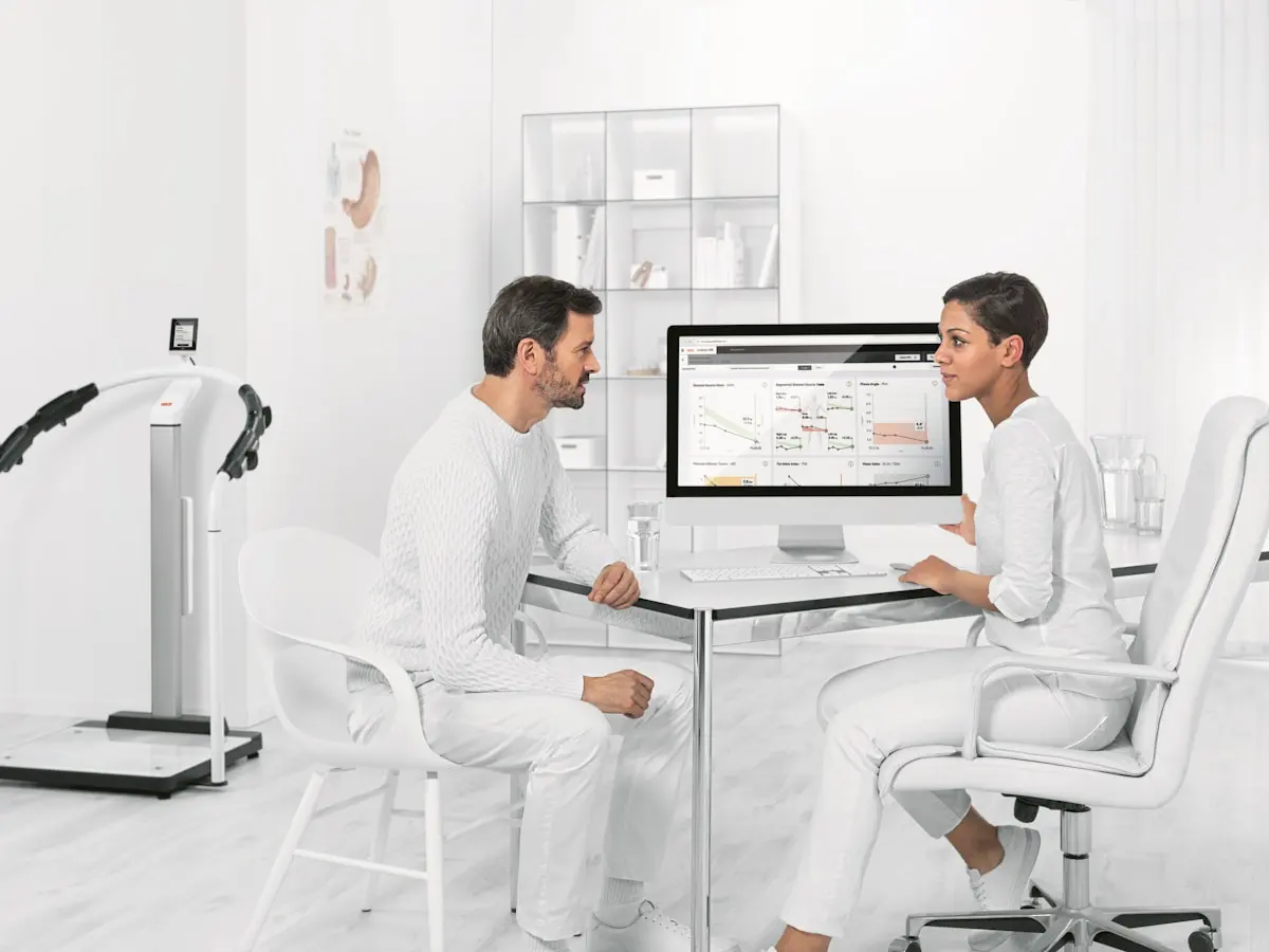 Clinician reviewing body-composition results during a weight-loss consultation